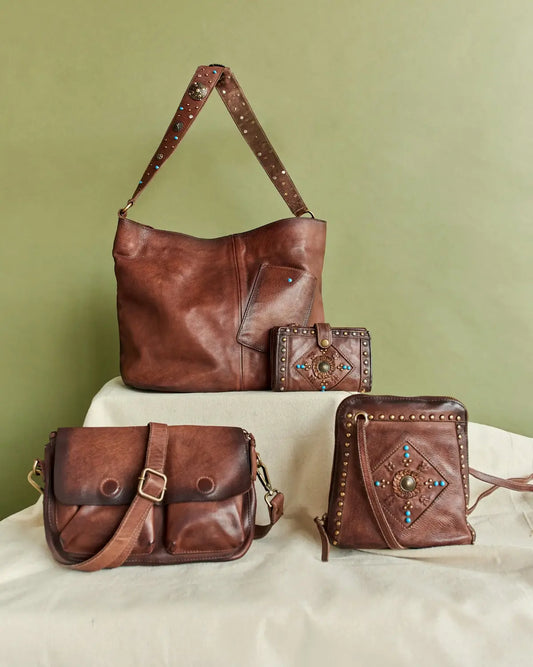 Elegant brown leather borse italiane with studded straps and turquoise accents.