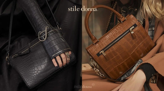 Black crocodile-embossed Italian handbag with silver hardware and cutout design.